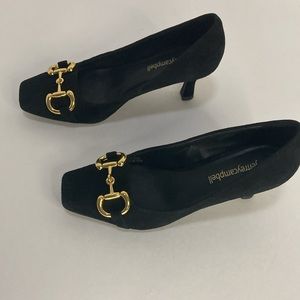 NWOT shoe goes with anything. Black heels with gold for that sophisticated look.
